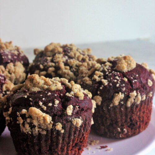 Chocolate beet muffins with brown sugar crumble in a pink plate.