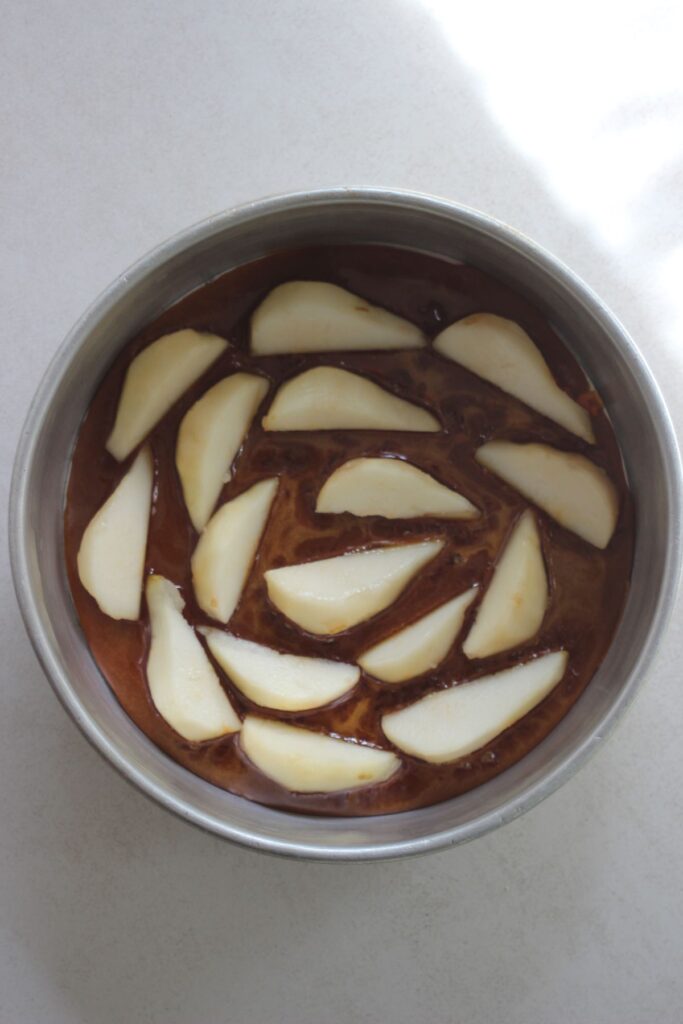 Cake pan with caramel a pear slices.