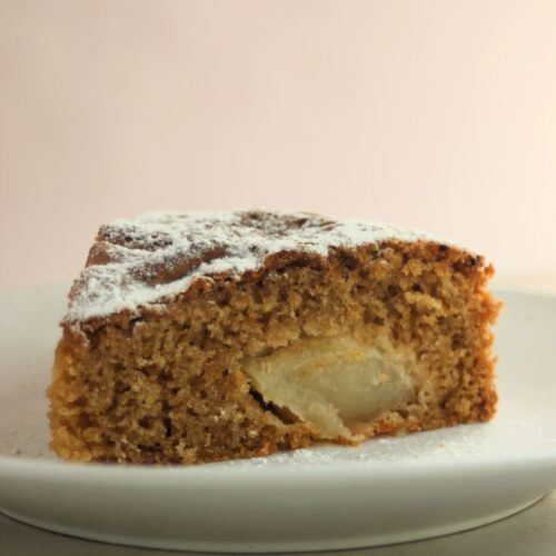 A portion of apple cake on a white plate.