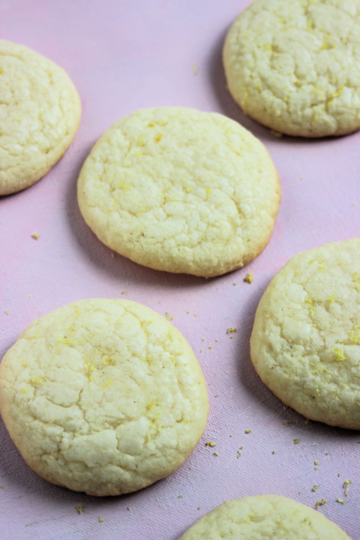Lemon cookies on a pink surface.