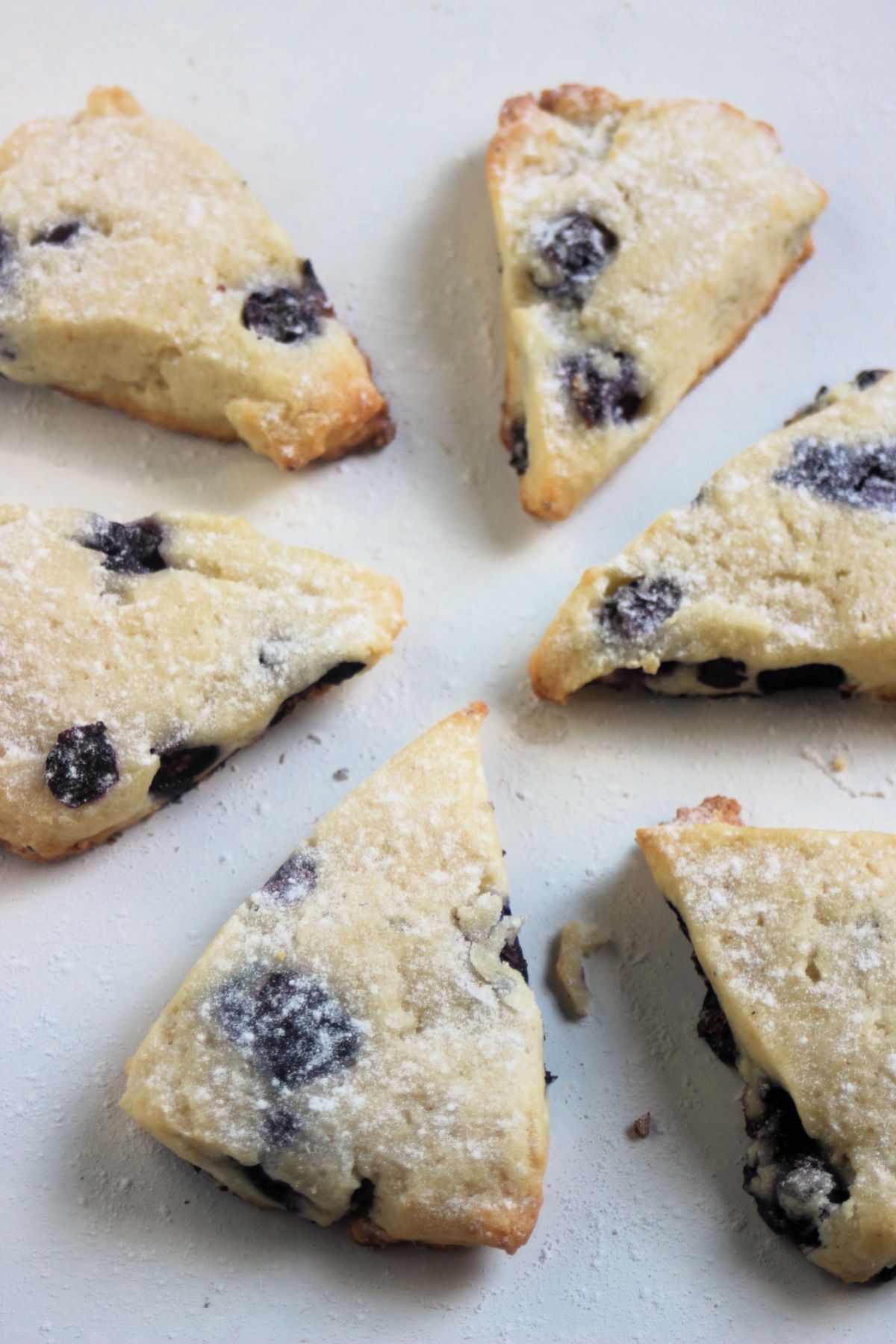 Blueberry scones on a white surface.