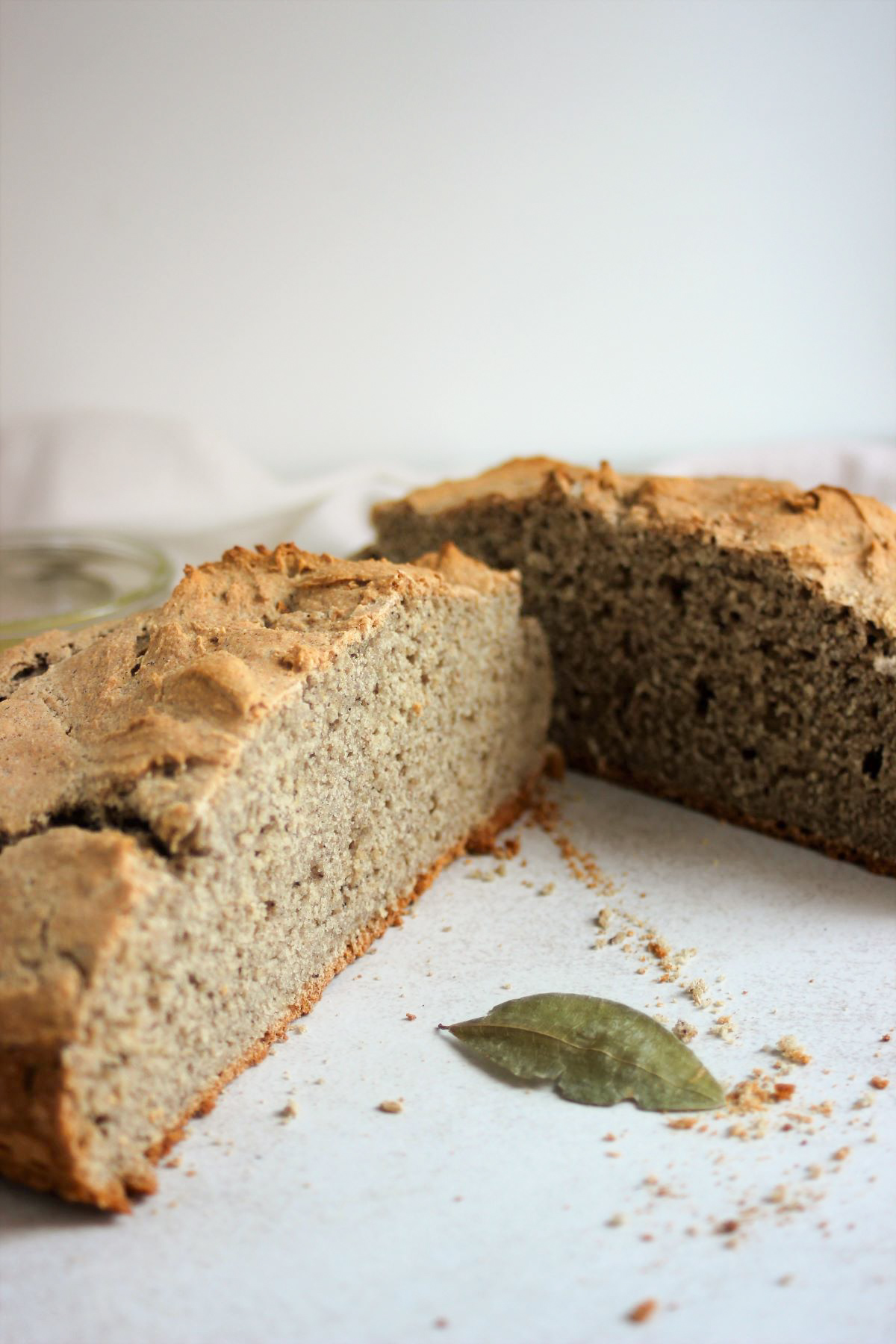 A soda bread cut into two halves on a white surface.