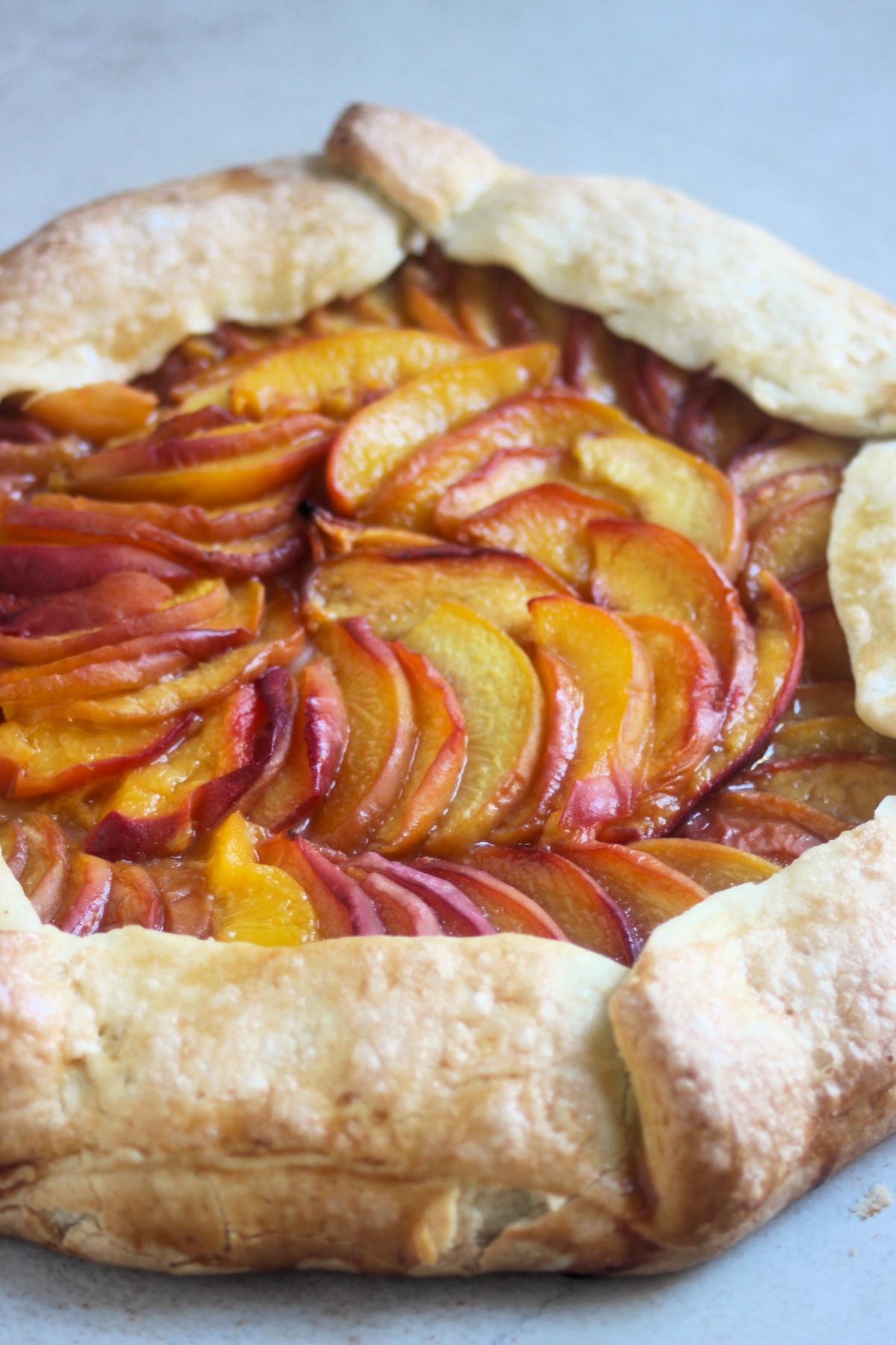 Peach galette on a white surface.