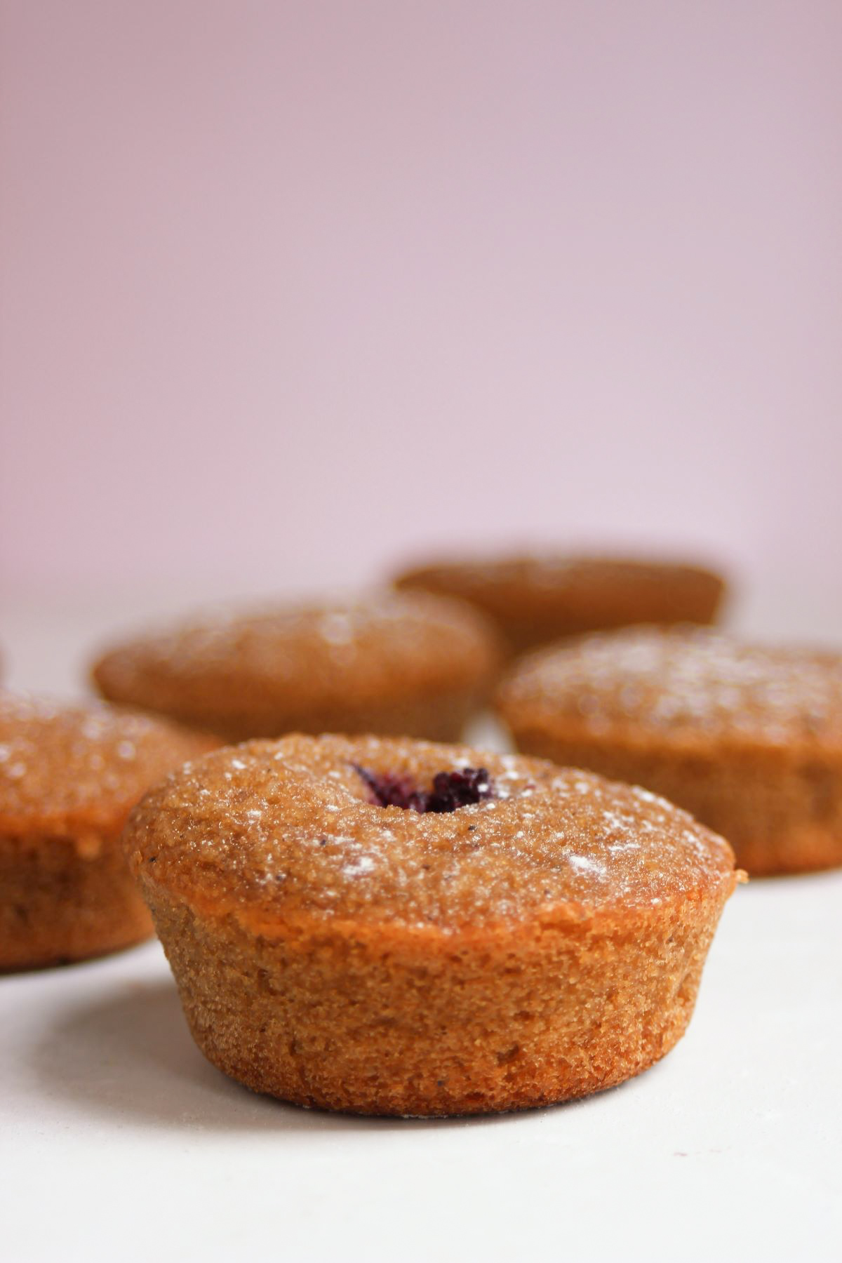 A financier on a white surface. Many financiers are in the background.