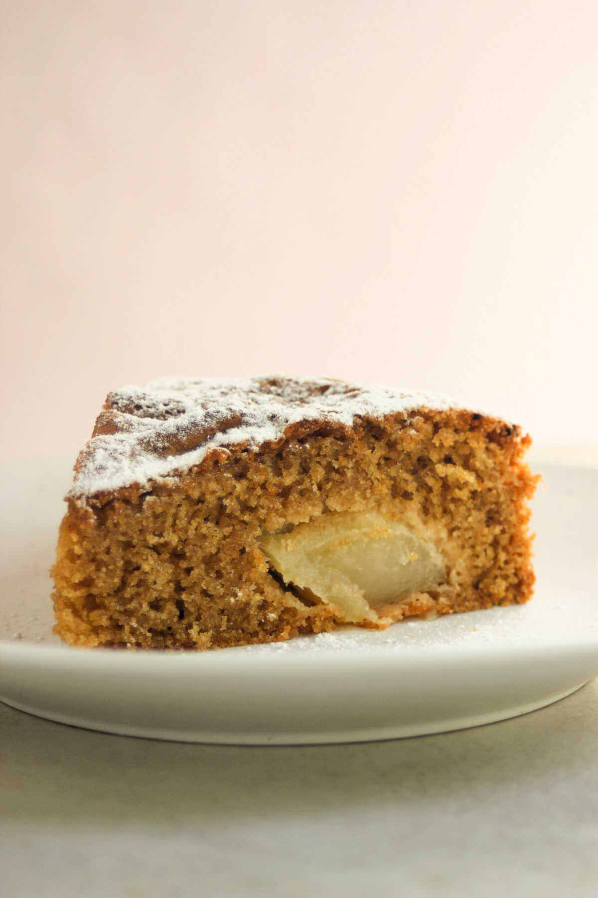 A portion of apple cake on a white plate.