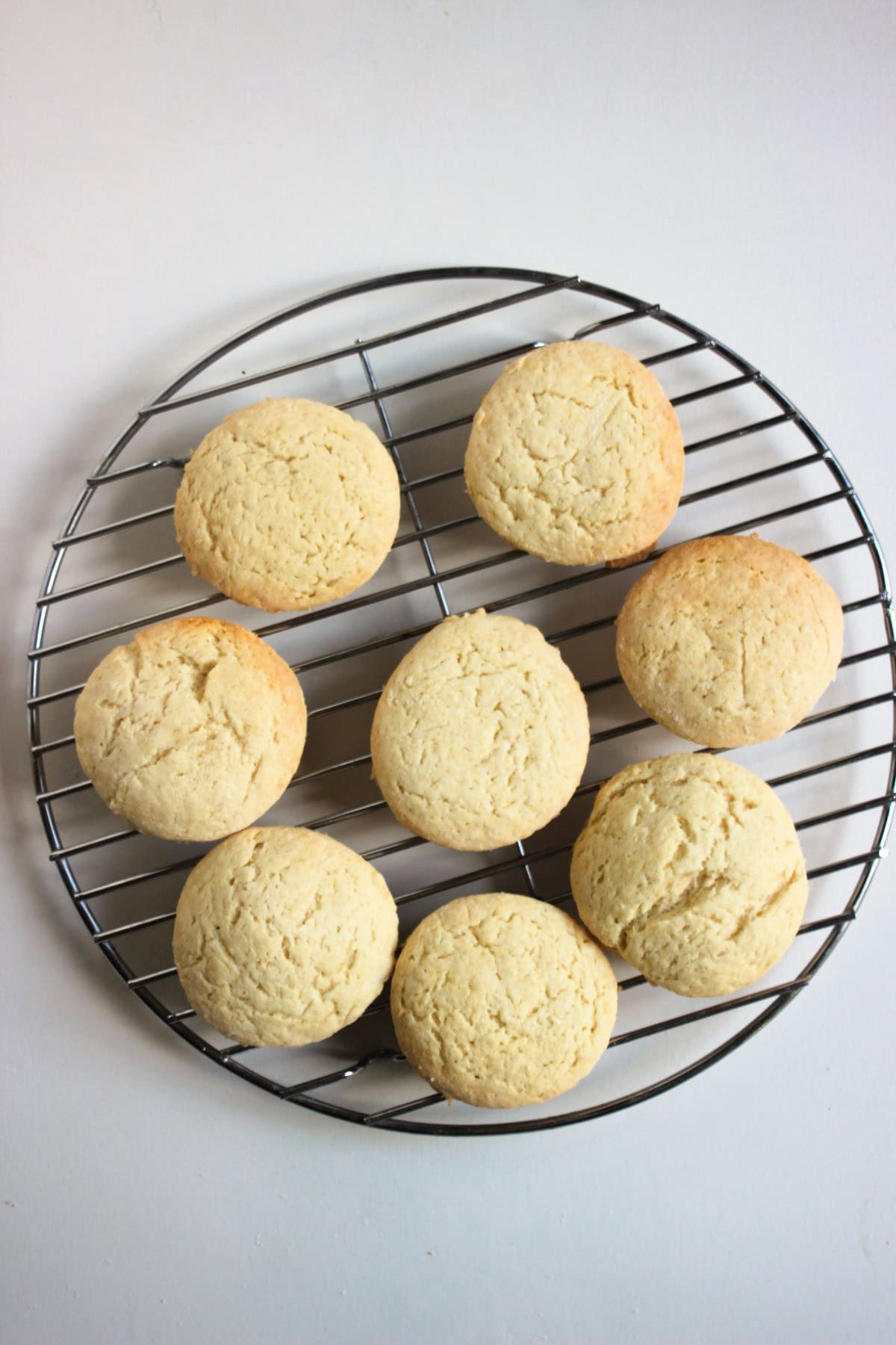 Biscuits on a round wire rack seen from above.