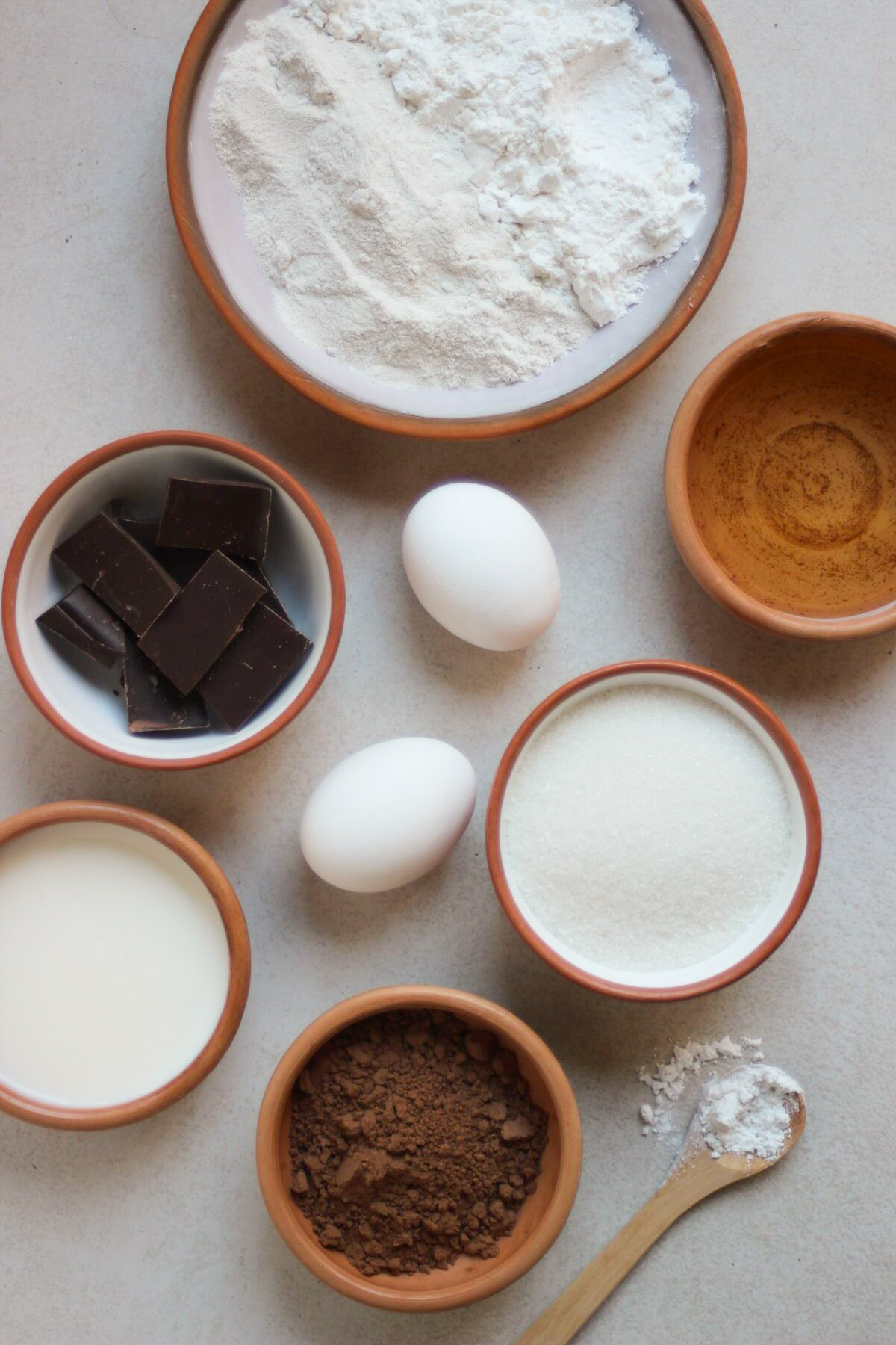 GF Chocolate buckwheat loaf cake ingredients on a white surface seen from above.