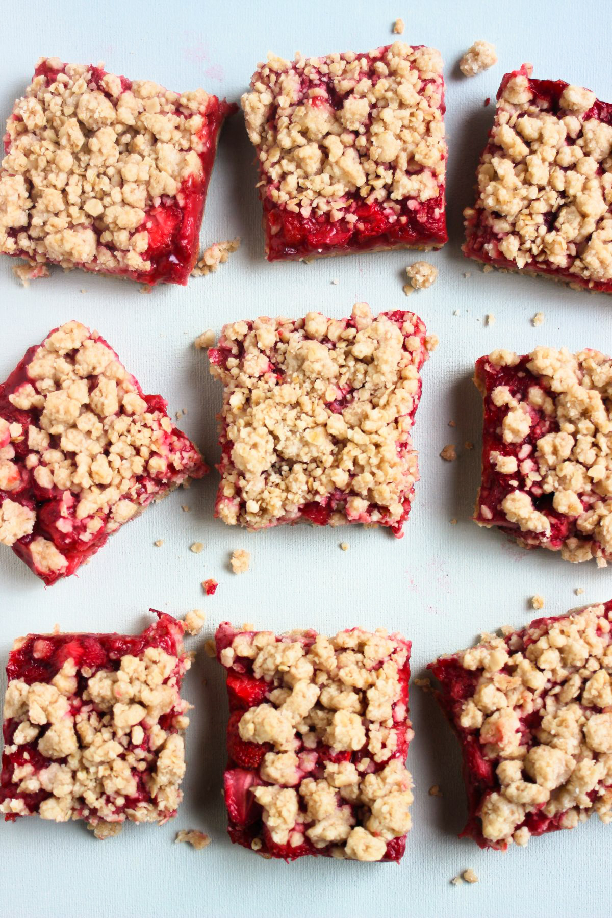 Strawberry bars on a white surface seen from above.