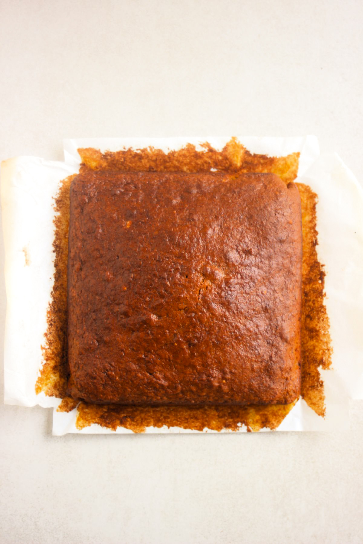 Top view of pumpkin cake on parchment paper.