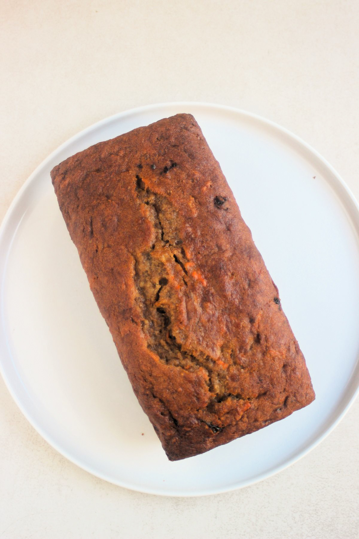 Top view of carrot banana bread on a white plate.