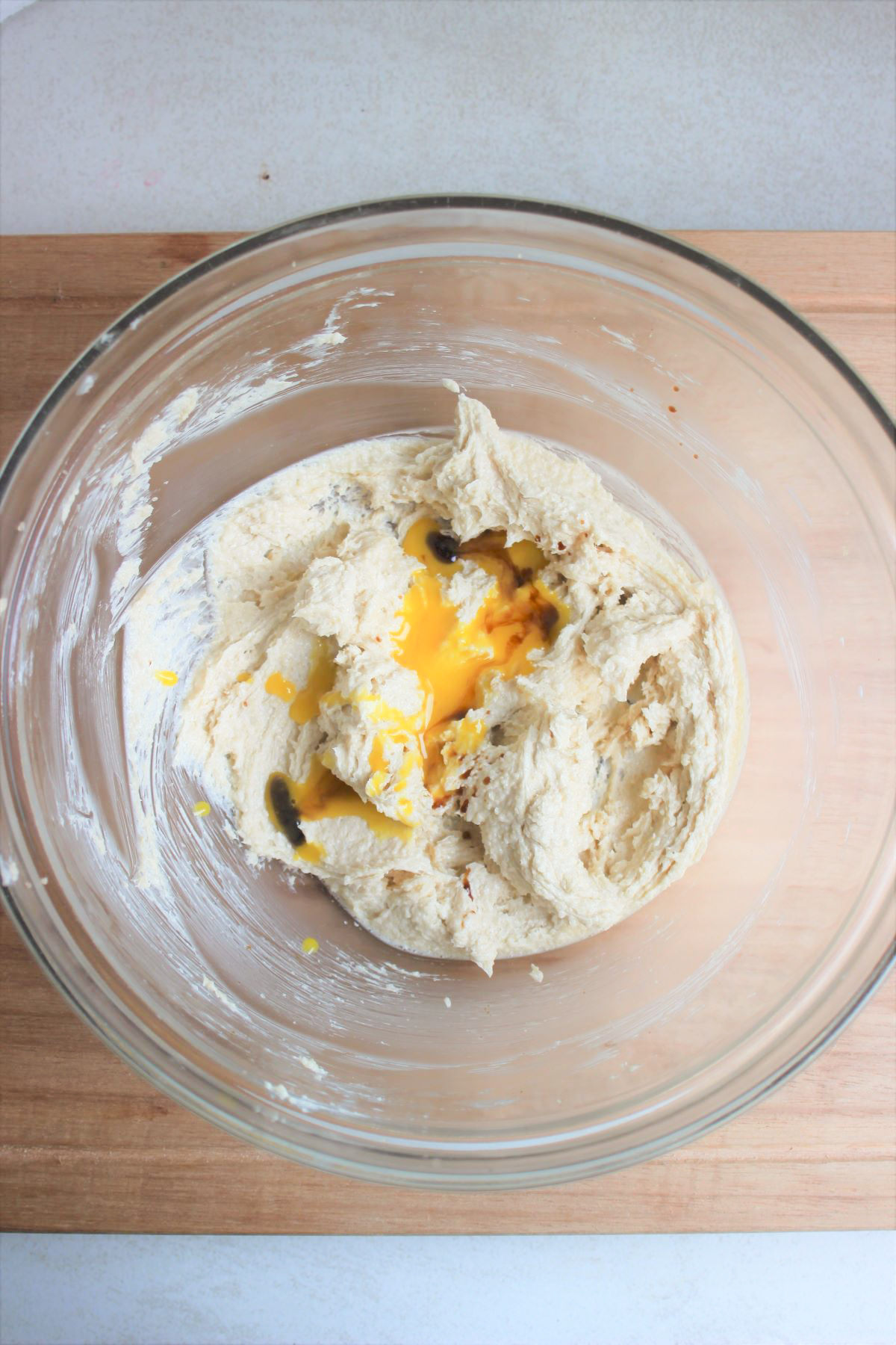 Glass bowl with a mixture that includes egg yolk.