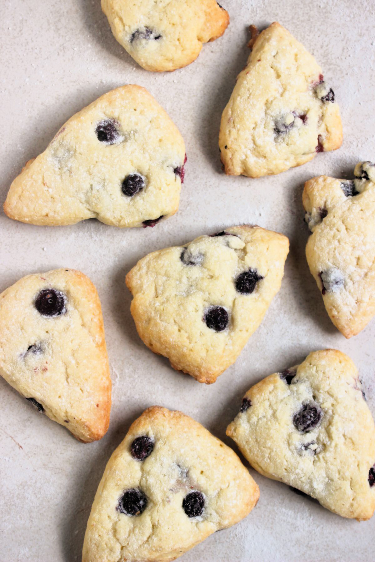 Blueberry scones on a white surface seen from above.