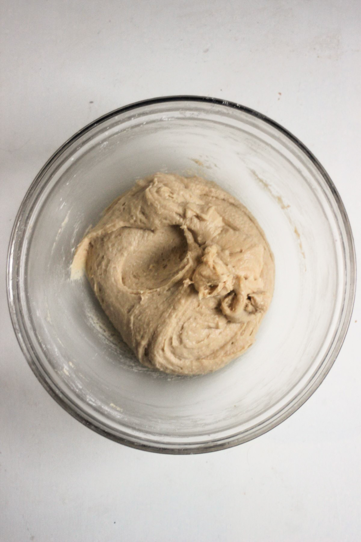 Glass bowl with smooth cookie dough.