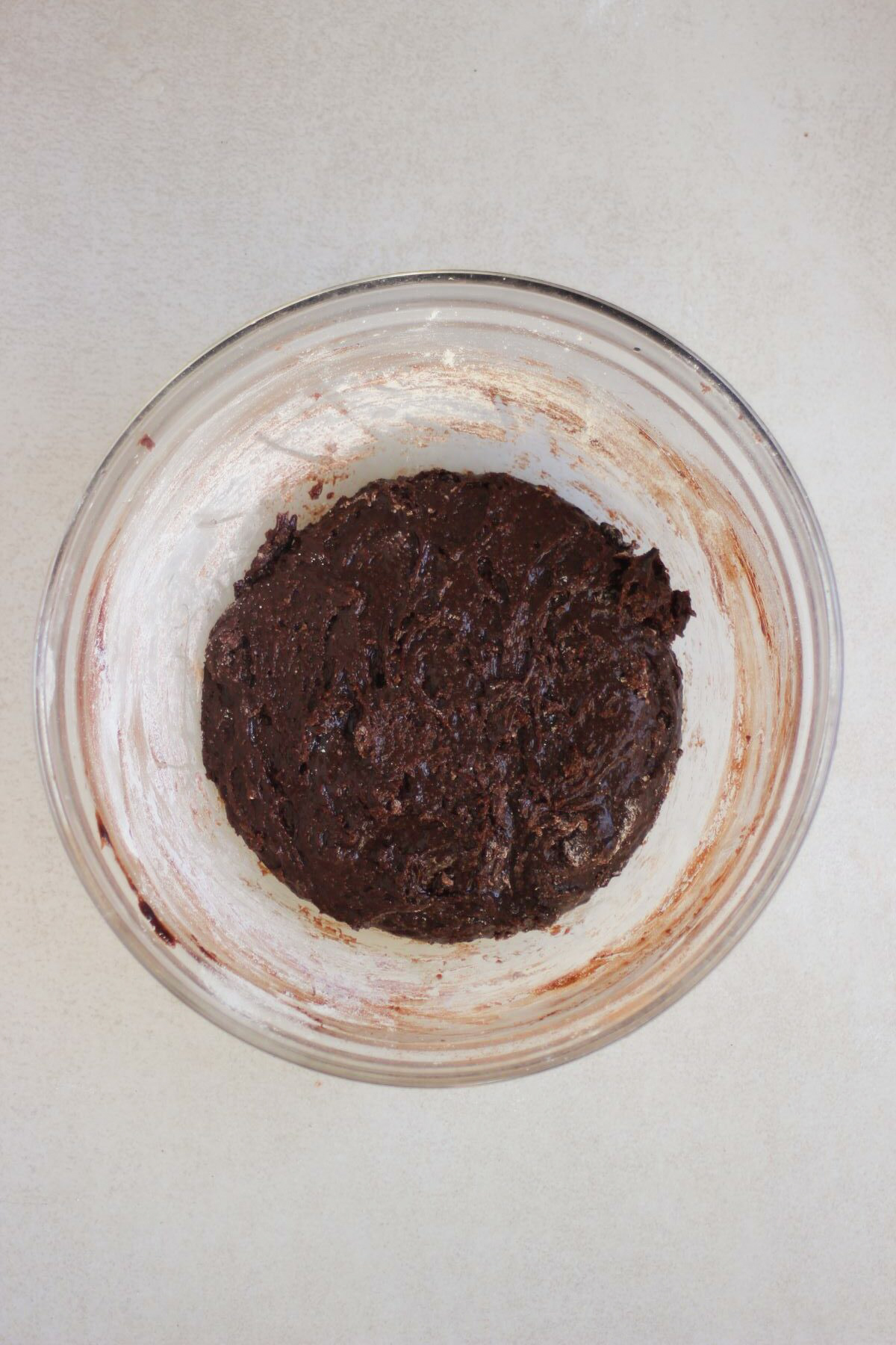 Glass bowl with a dark brown sticky mixture.