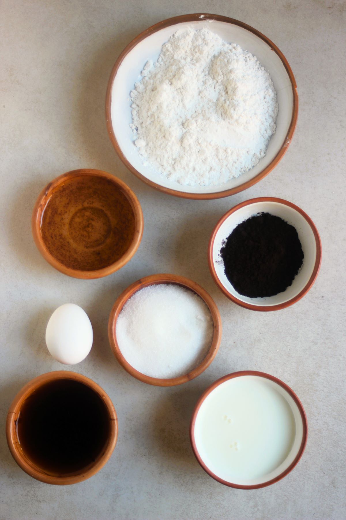 Chocolate cupcakes ingredients on a white surface seen from above.