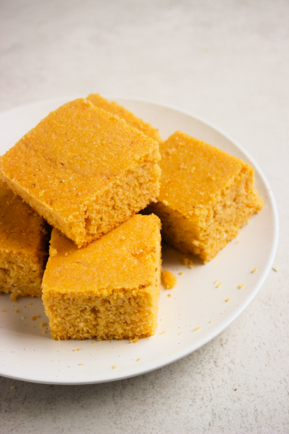 Cornbread pieces on a white plate.