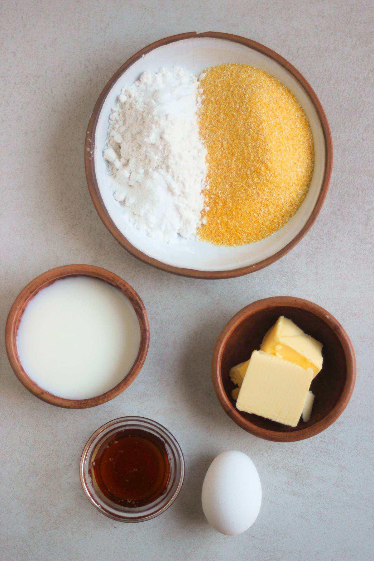 Cornbread muffins ingredients on a white surface seen from above.