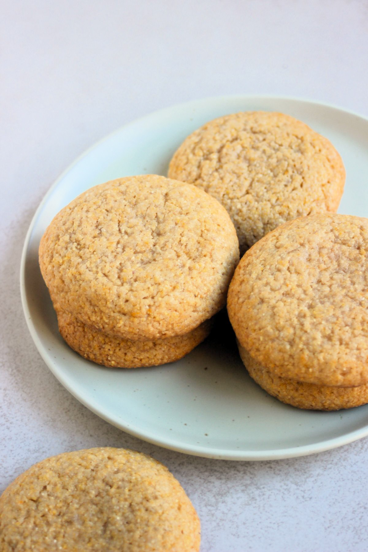 Cornmeal cookies on an aqua-green plate.
