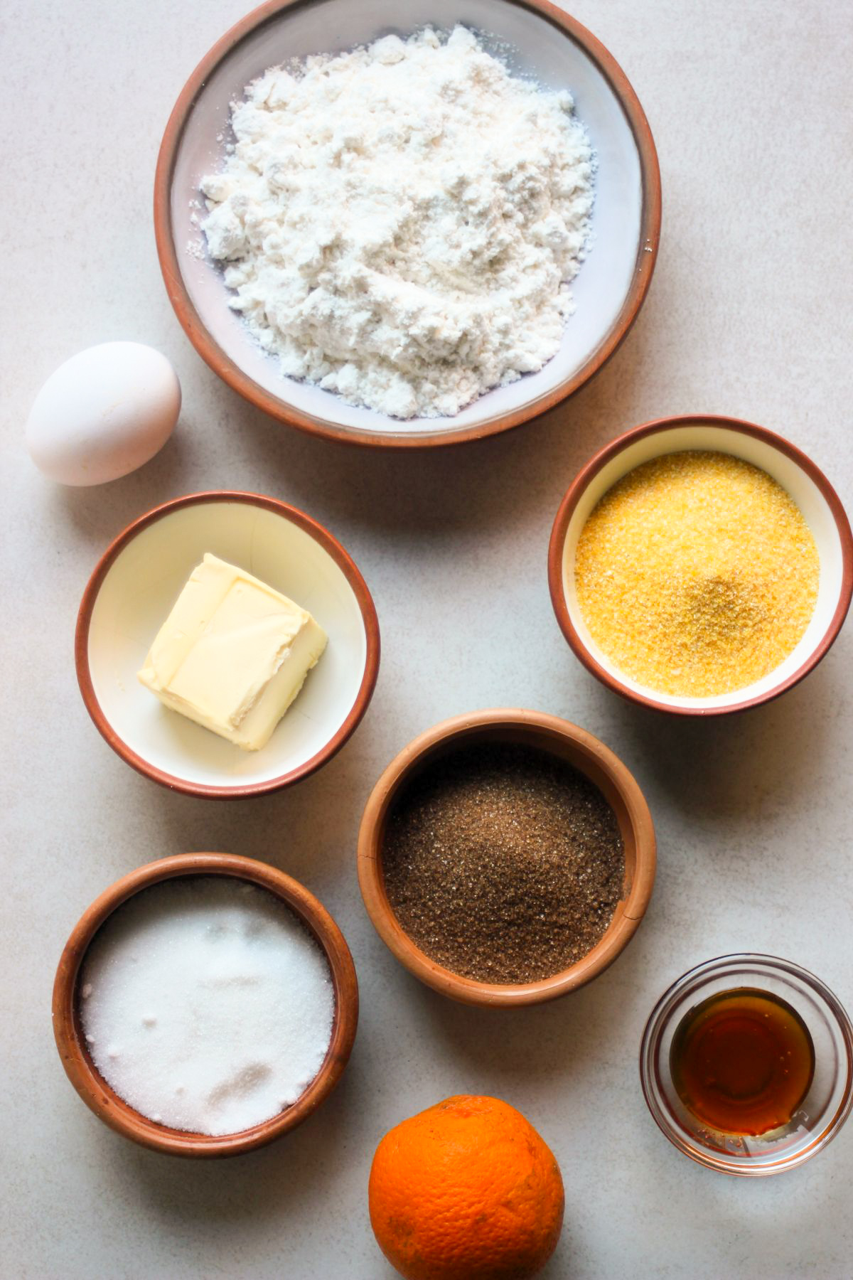 Cornmeal cookies ingredients on a white surface seen from above.