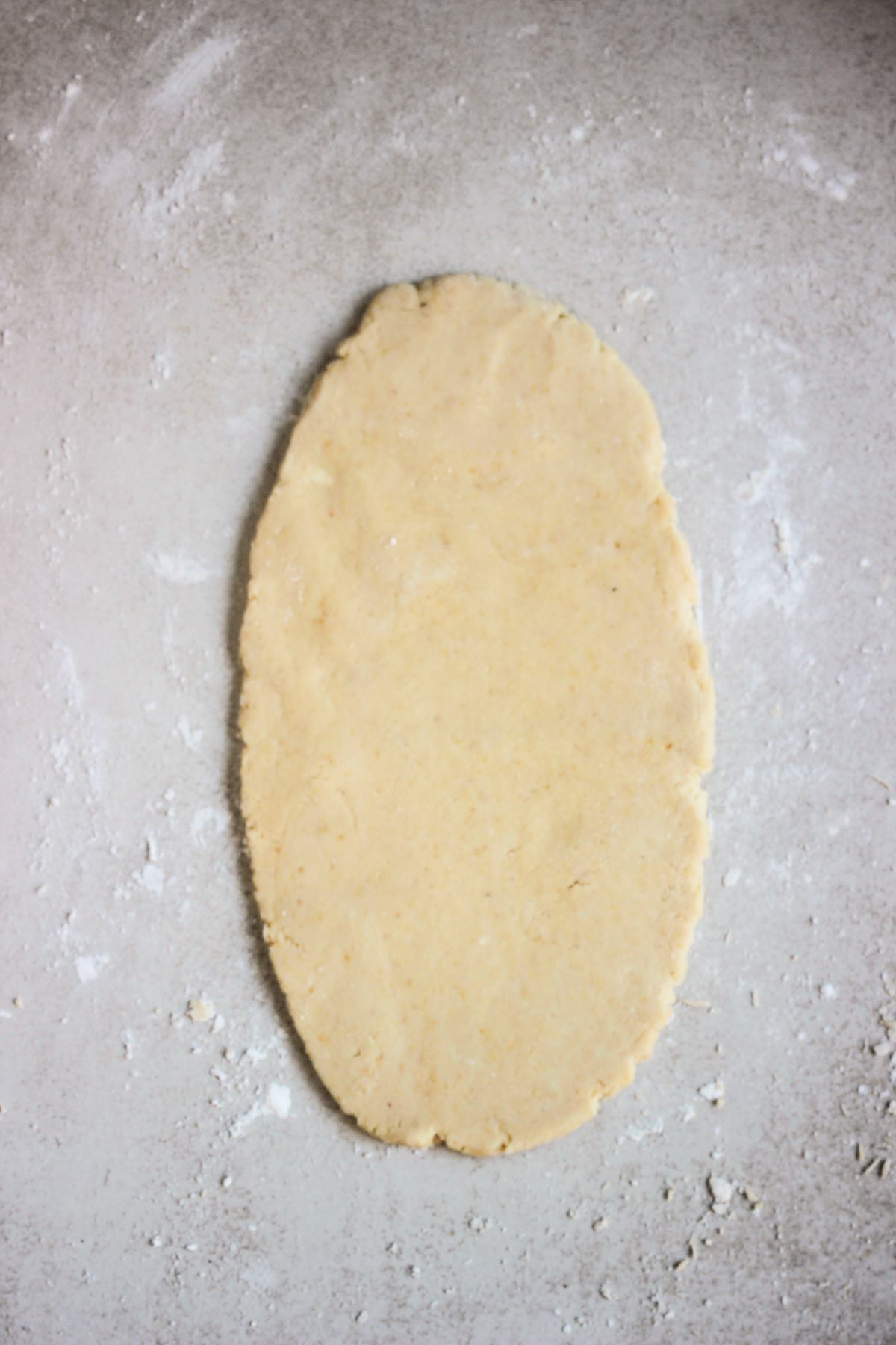 Circle of flatbread dough cut into 6 triangles. on a white surface.