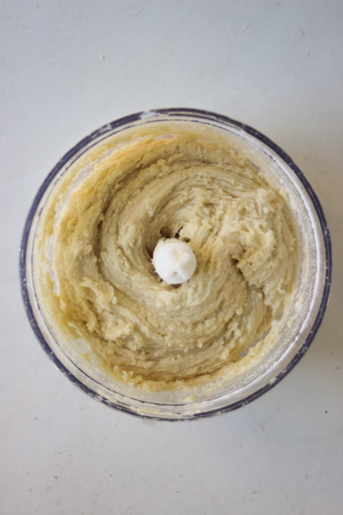 Food processor with a smooth mixture seen from above.