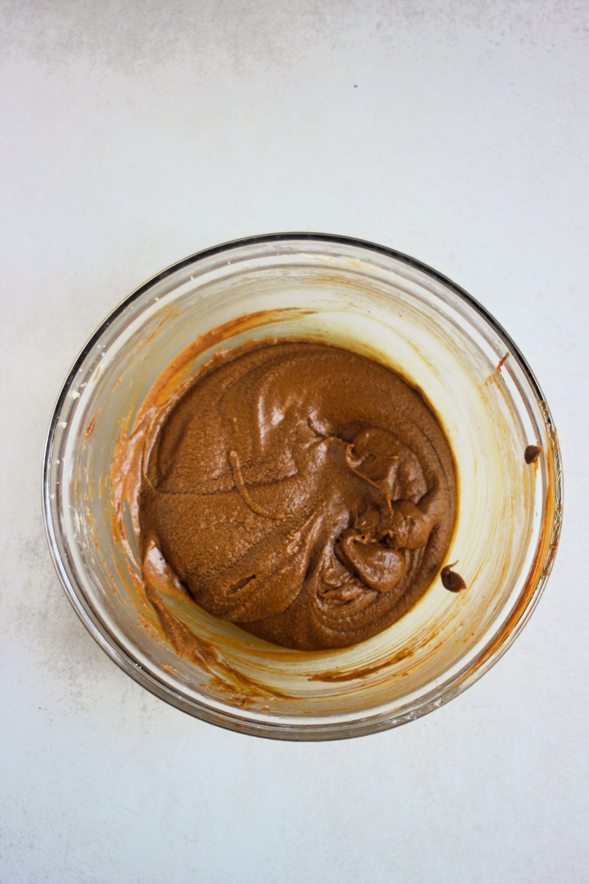 Glass bowl with a brown mixture.