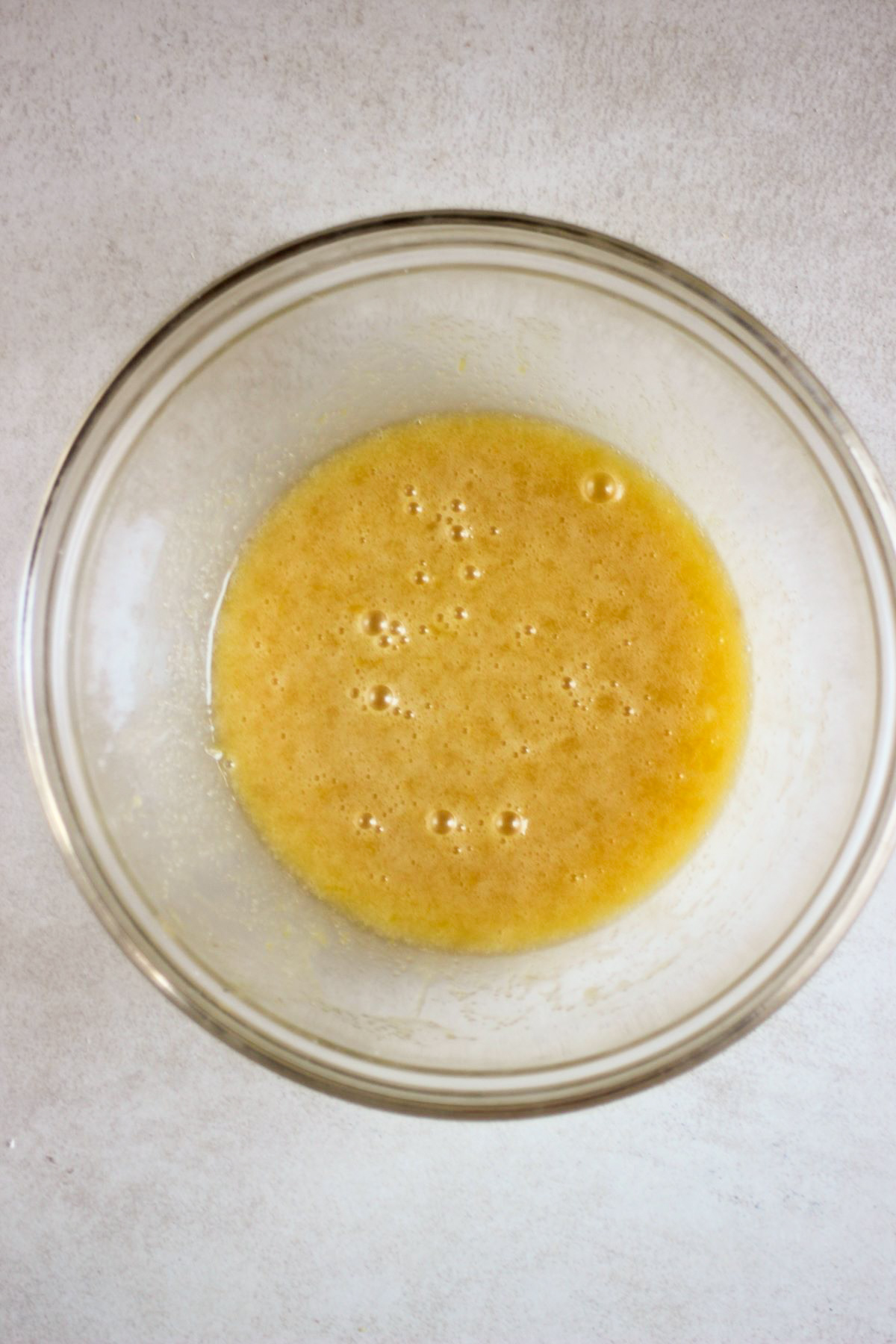 Glass bowl with a yellow mixture.