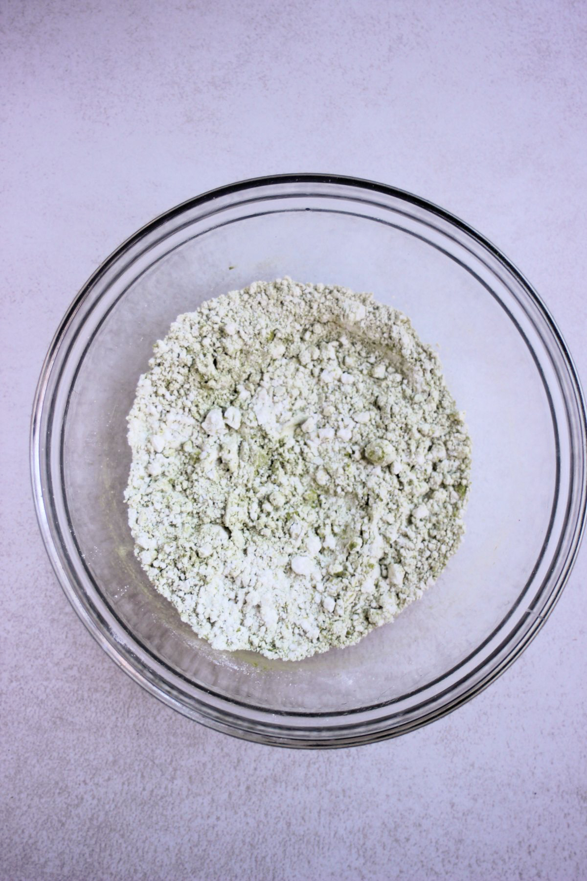 Glass bowl with flour and matcha.