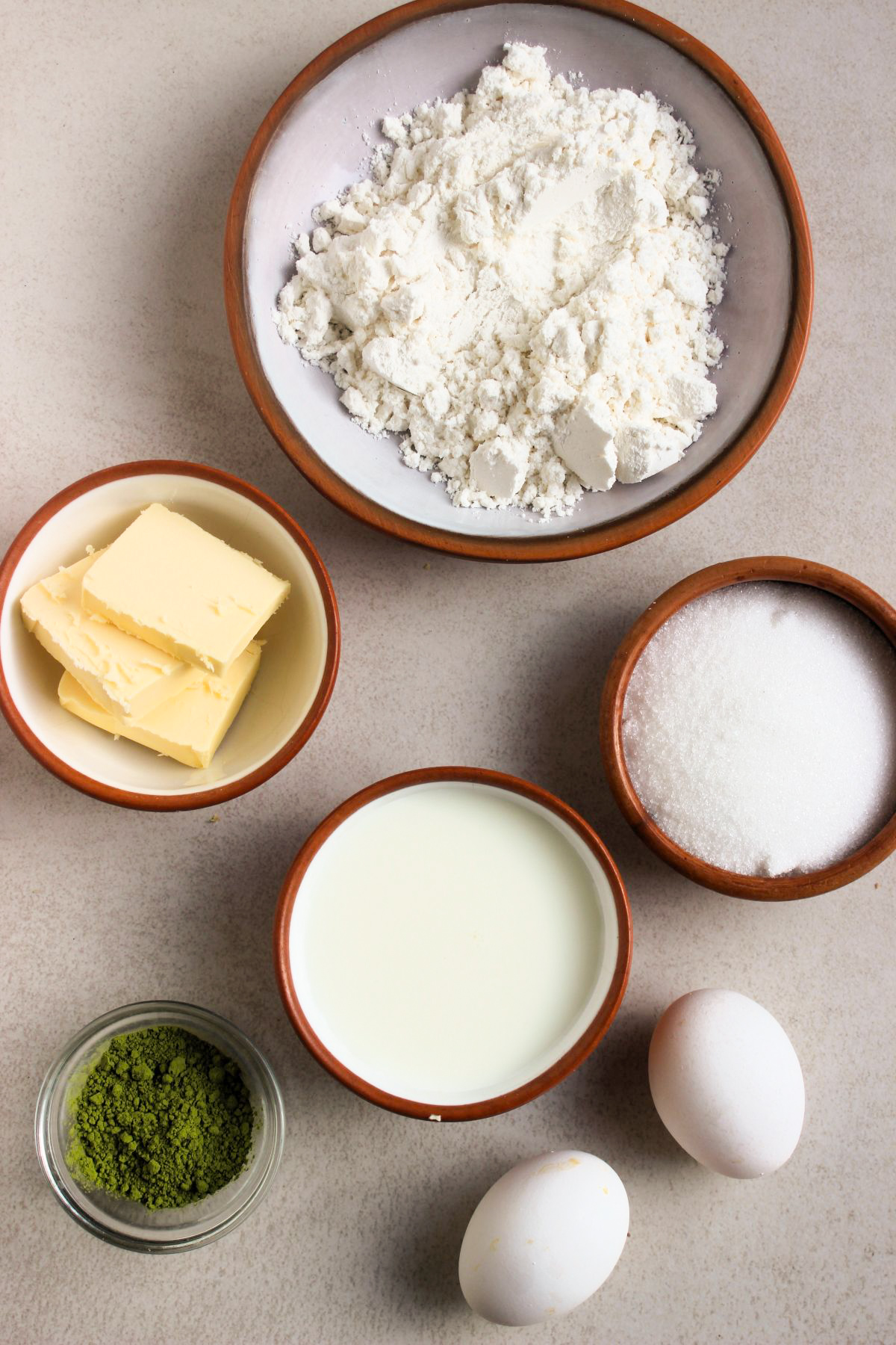 Matcha cupcakes ingredients on a white surface seen from above.
