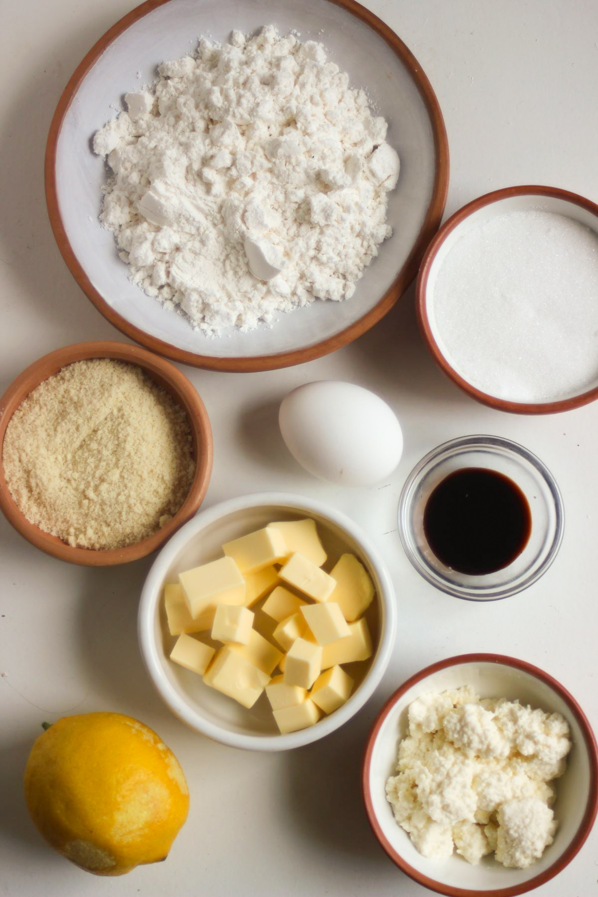 Lemon Ricotta Cookies ingredients on a white surface seen from above.