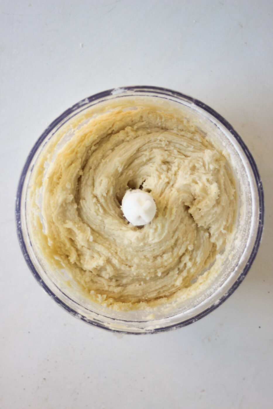 Food processor with a smooth mixture seen from above.