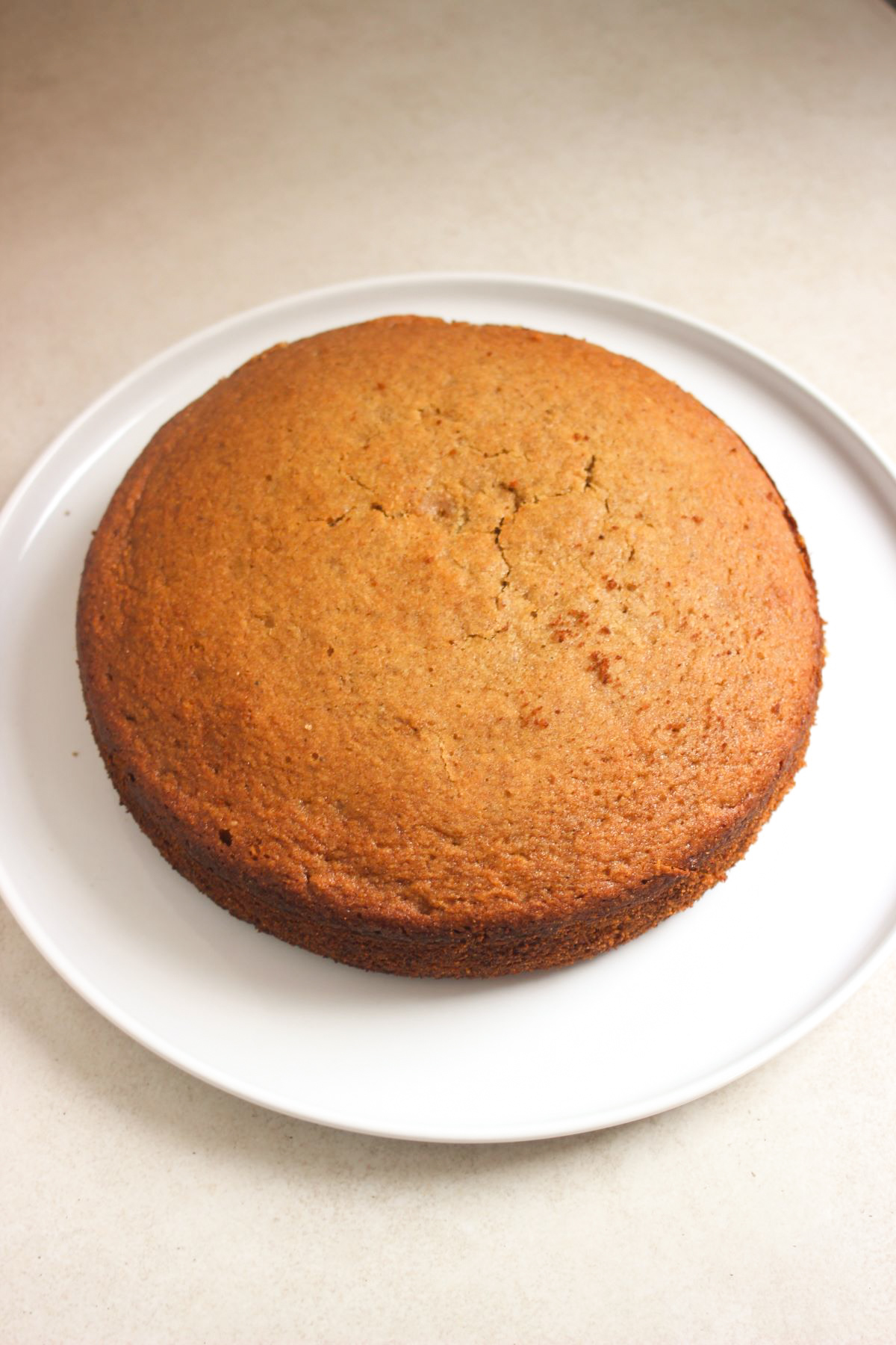 Sweet potato cake unfrosted on a white plate.