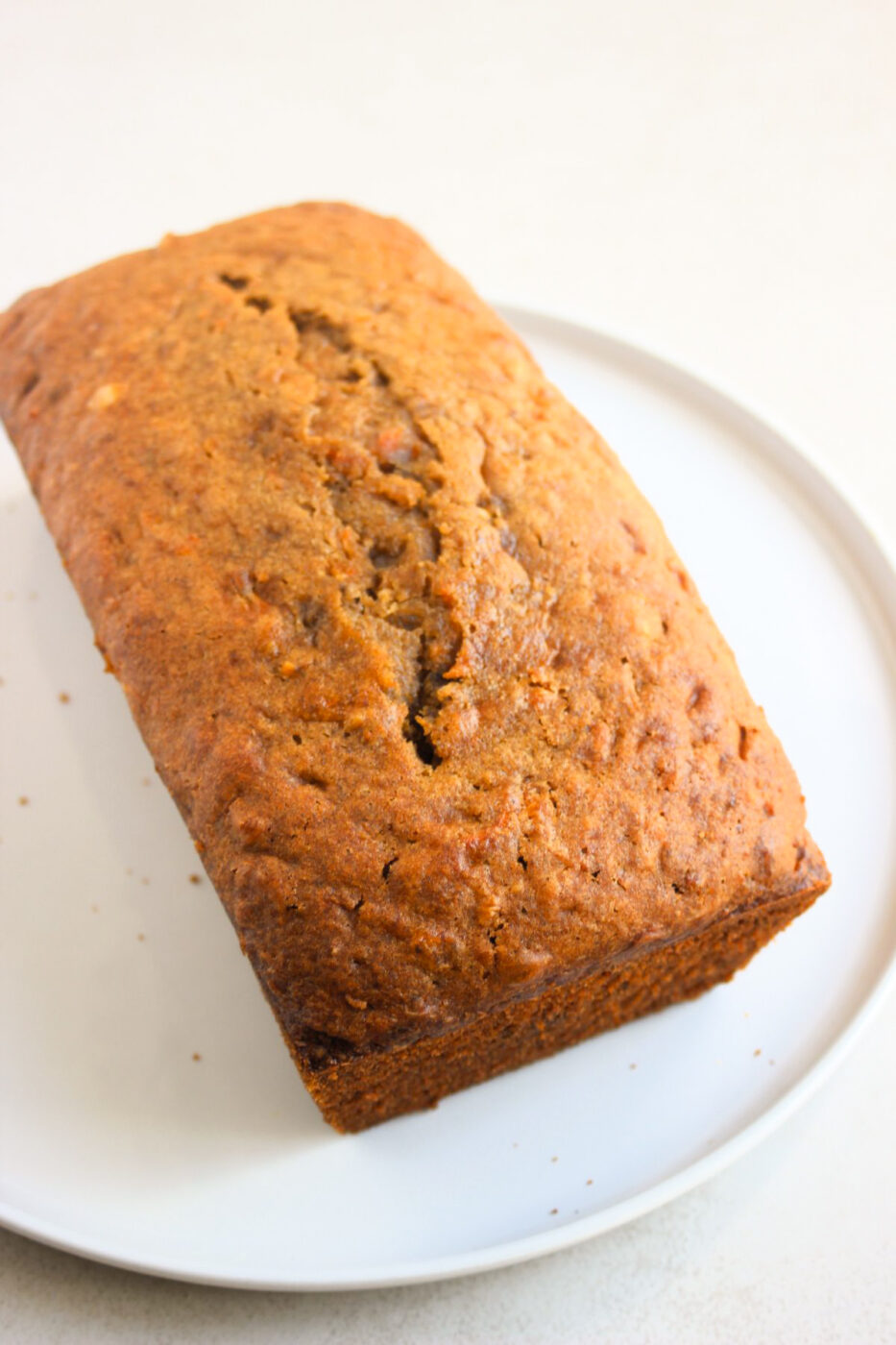 Carrot loaf cake on a white plate.