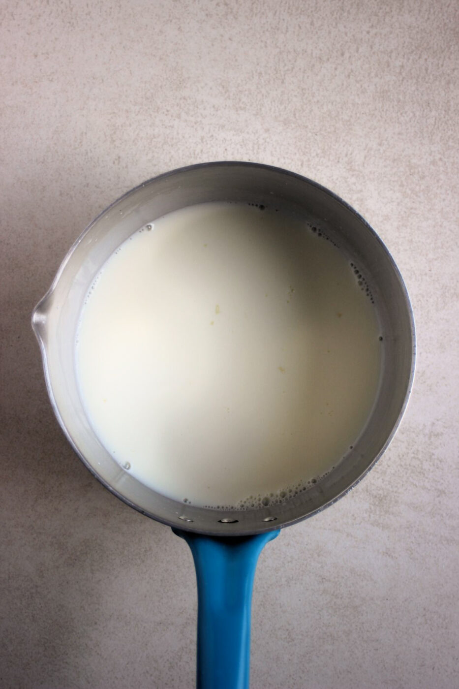 Top view of deep pan with milk.