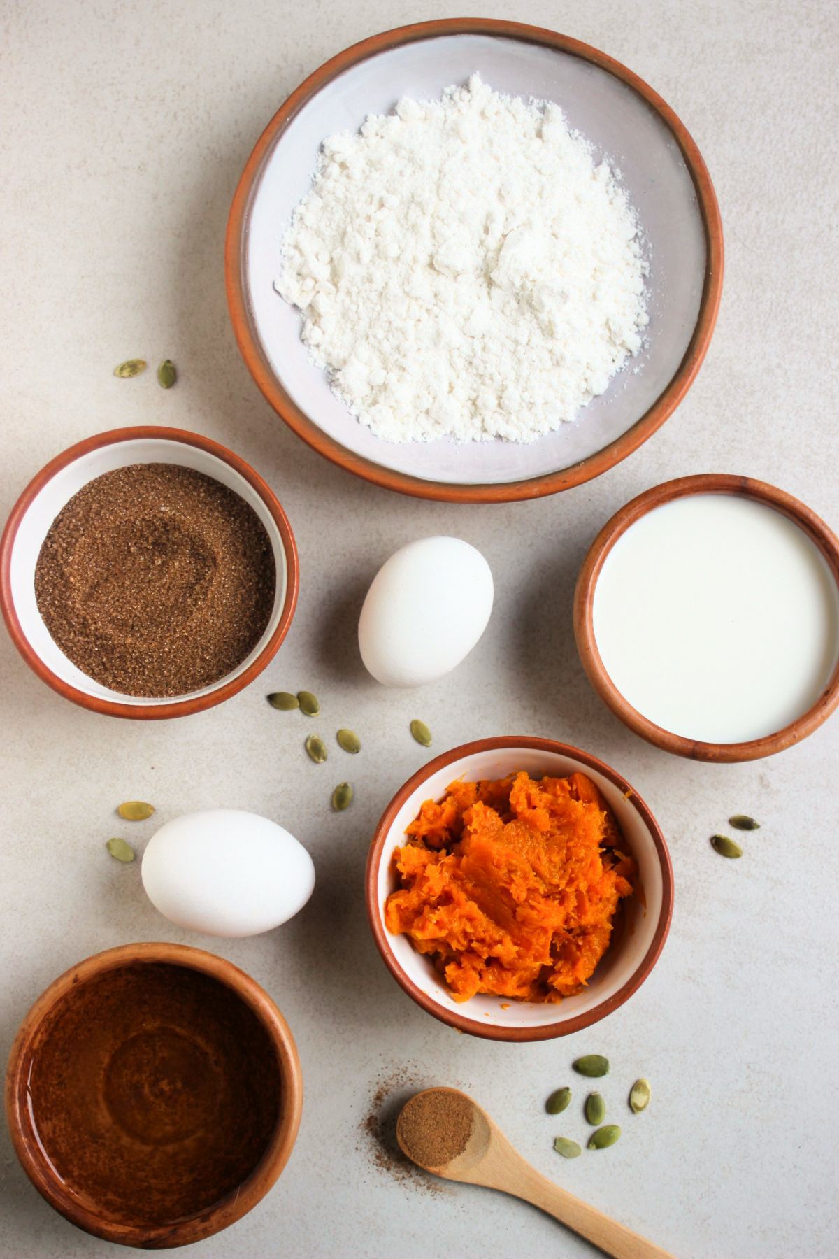GF easy Pumpkin muffins ingredients on a white surface seen from above.