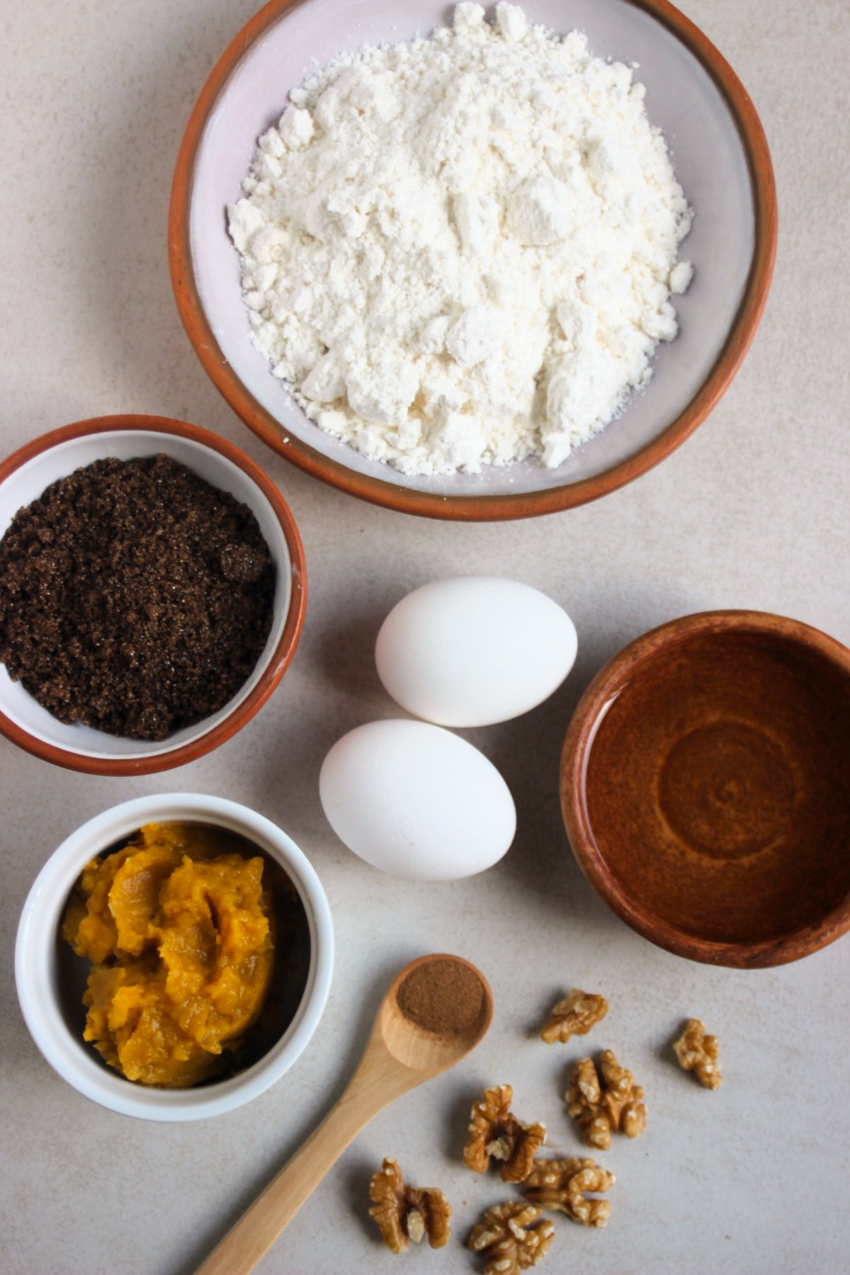 Top view of sweet potato muffins ingredients on a white surface.