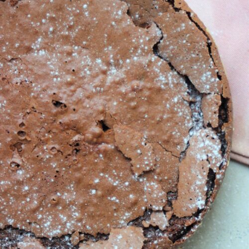 Chocolate cake sprinkled with powdered sugar.