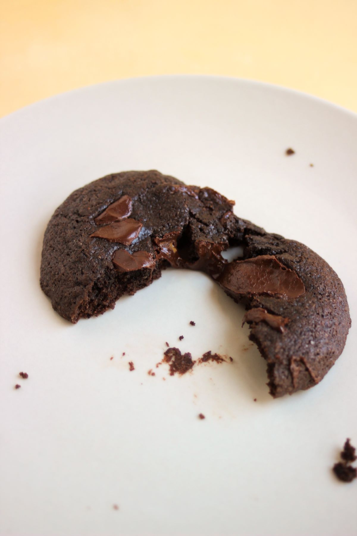 Chocolate cookie cut in two on a white plate.