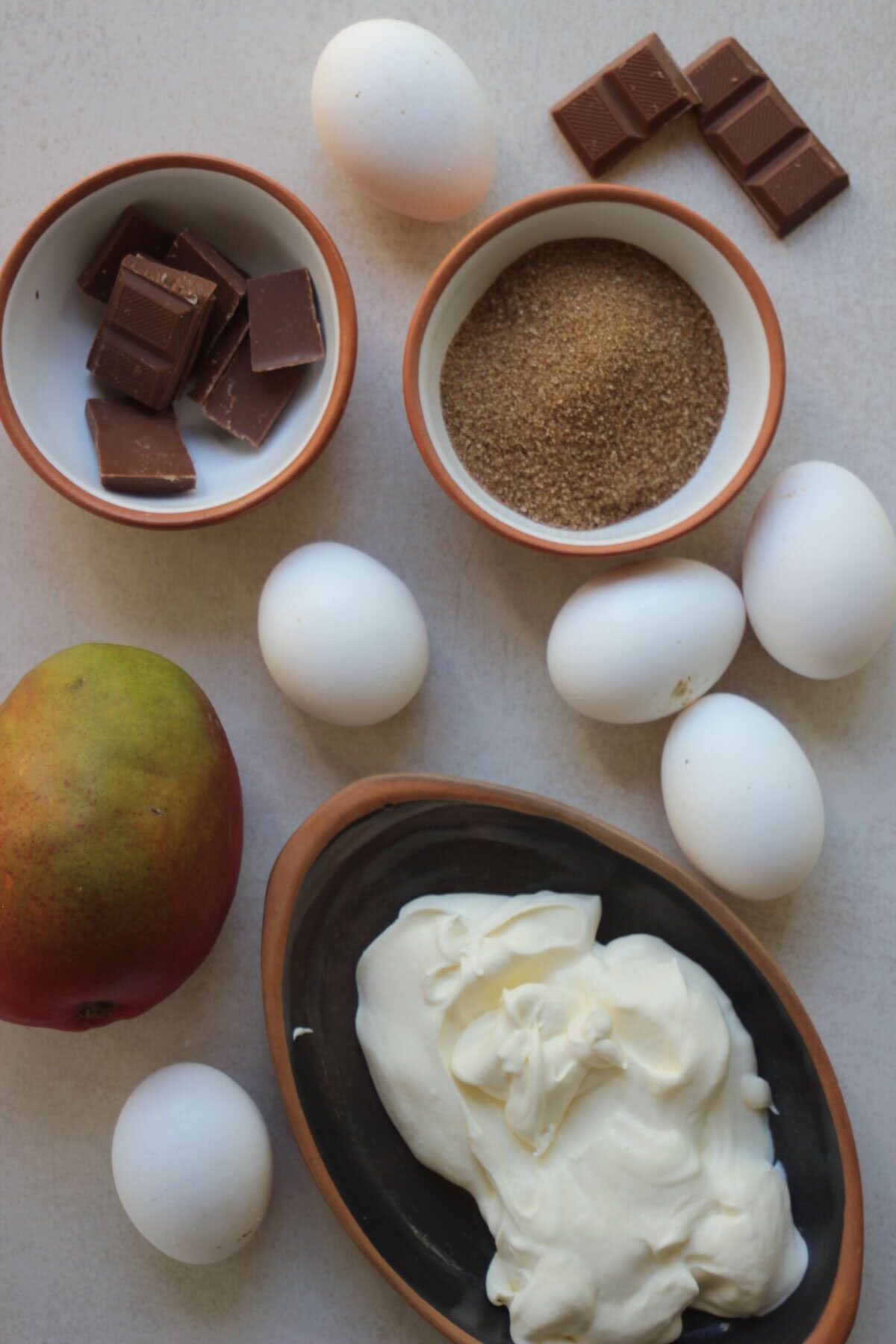Chocolate mousse and mango compote ingredients seen from above.