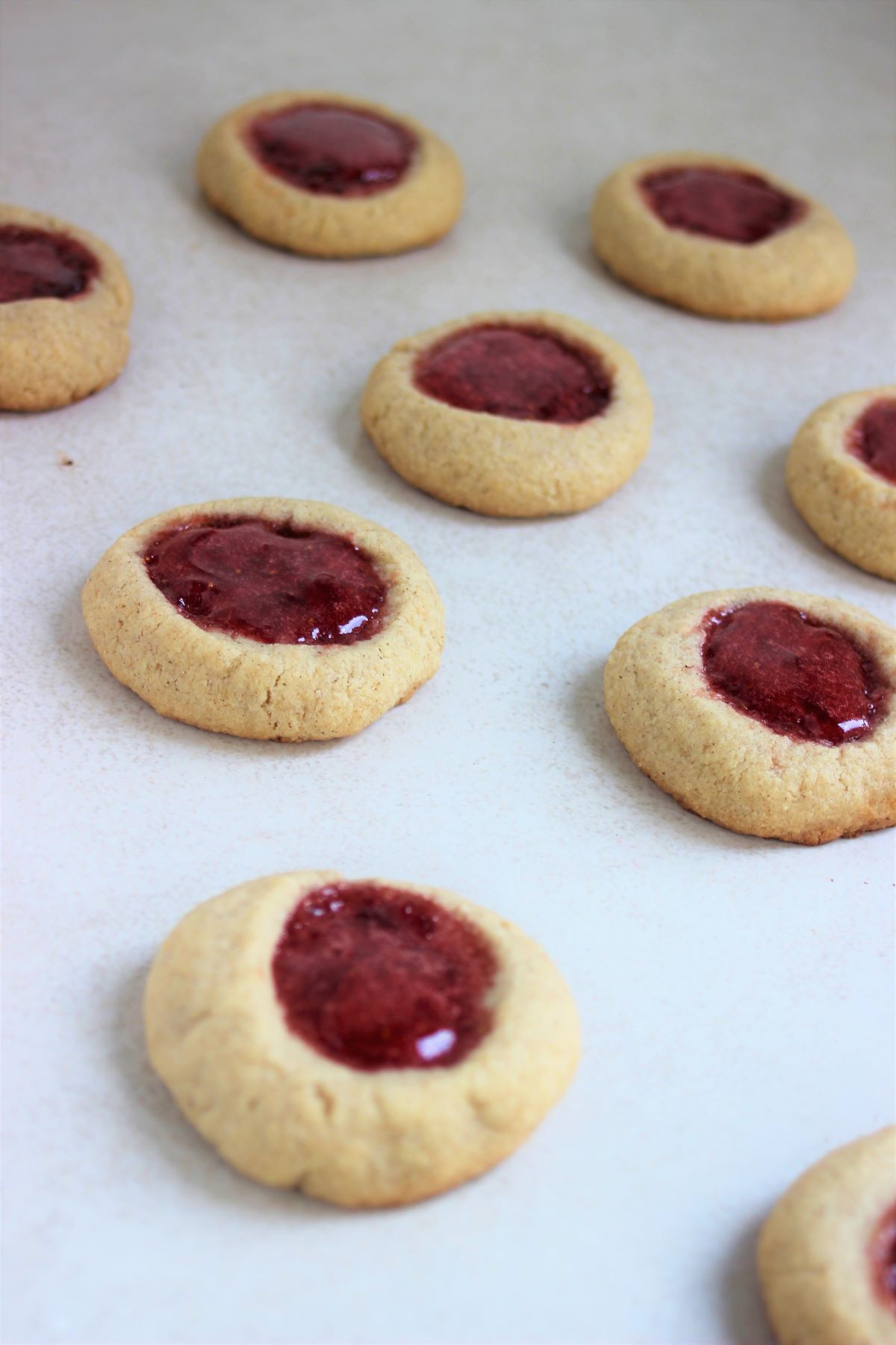 Thumbprints cookies on a white surface.