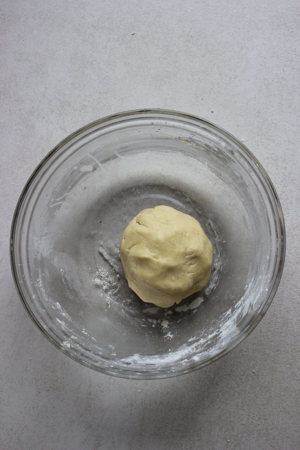 A cookie dough ball on a glass bowl.