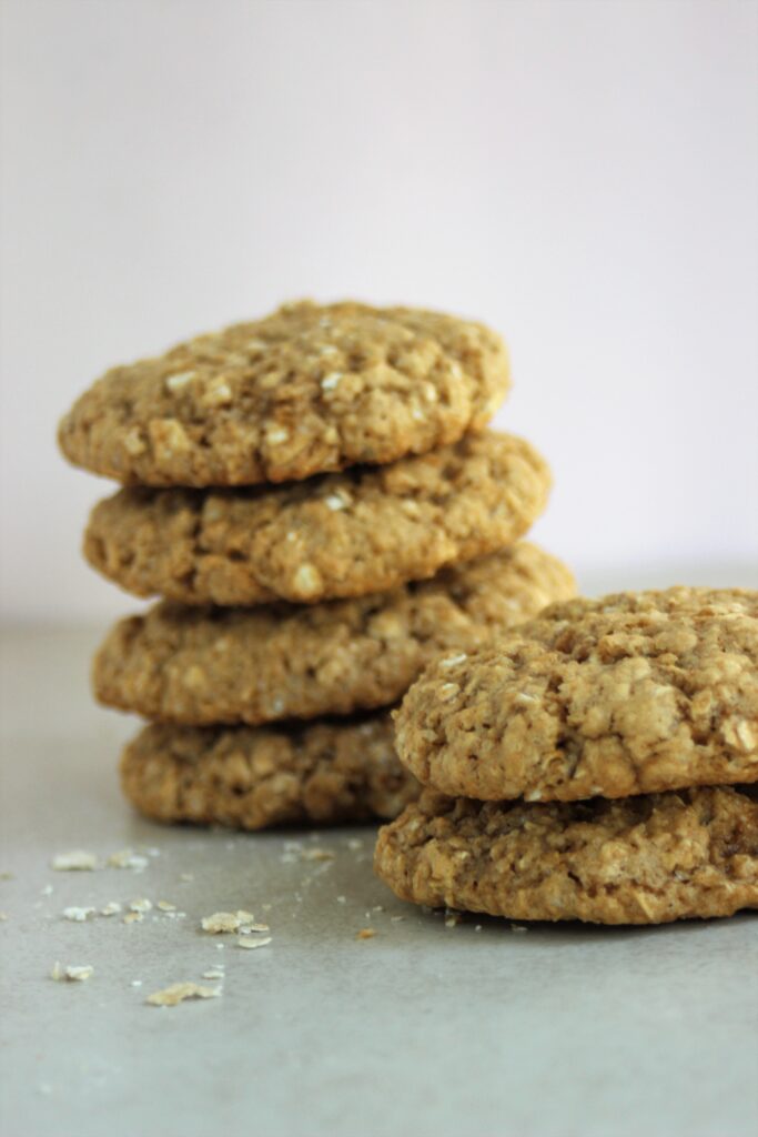 Two towers of oat peanut butter cookies on a white surface.