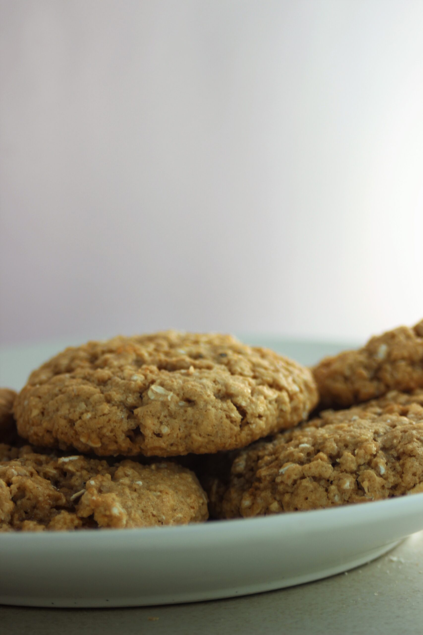 Oat peanut butter cookies on a white plate.