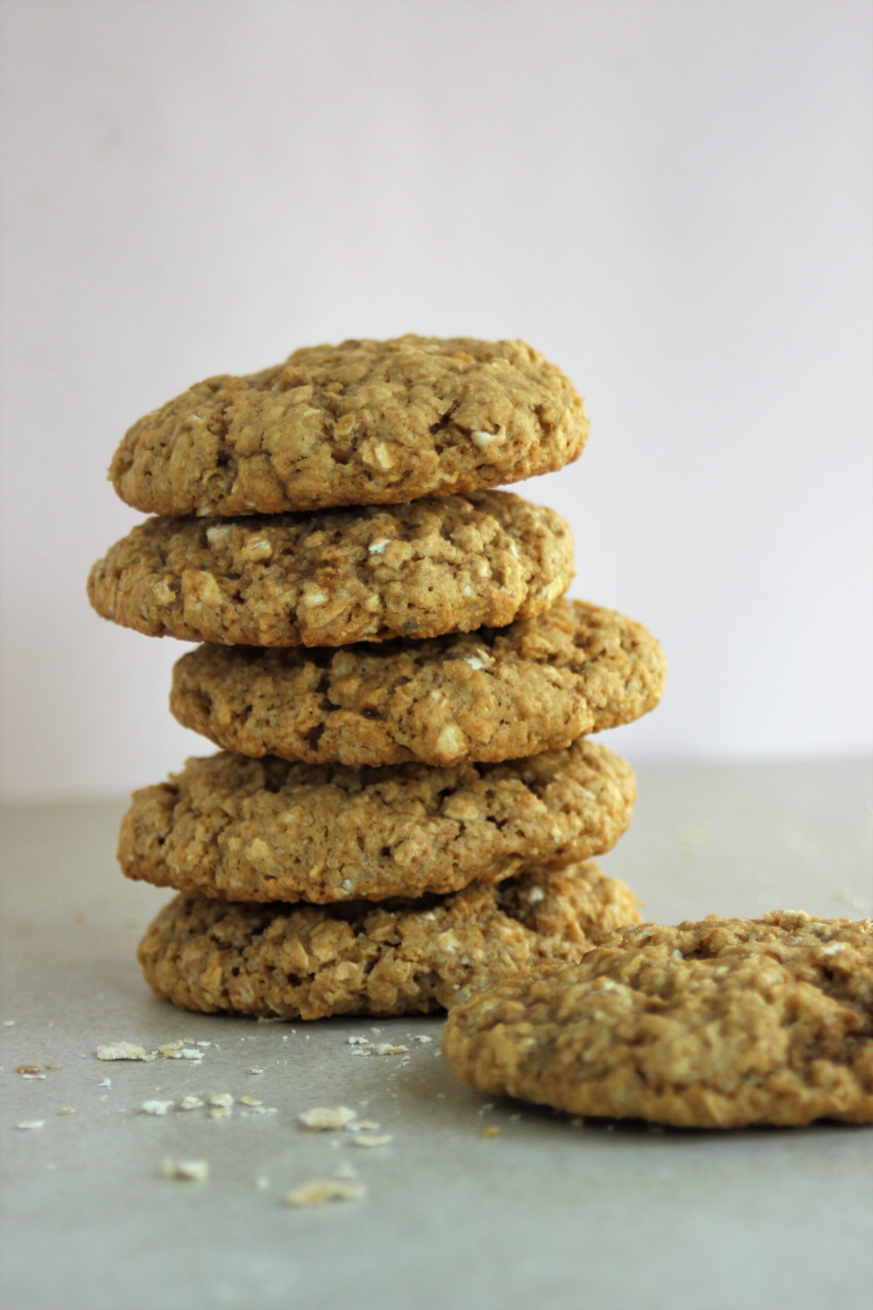 A tower of oat peanut butter cookies on a white surface.