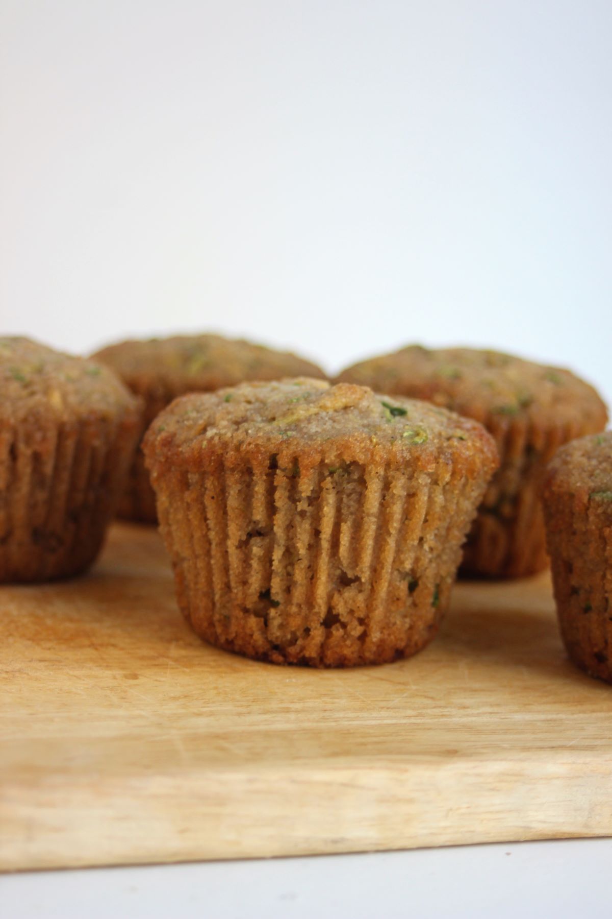 Zucchini muffins on a wooden board.