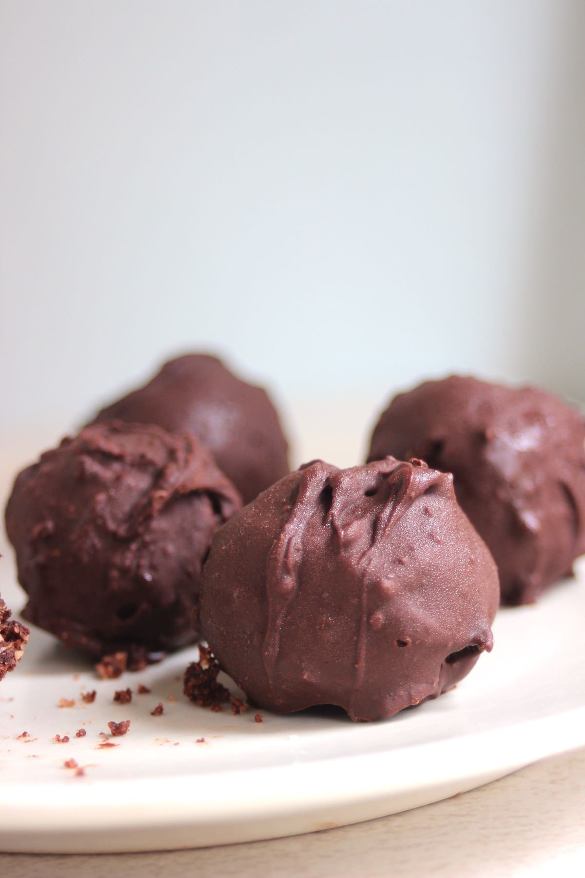 Chocolate peanut butter balls on a white plate.