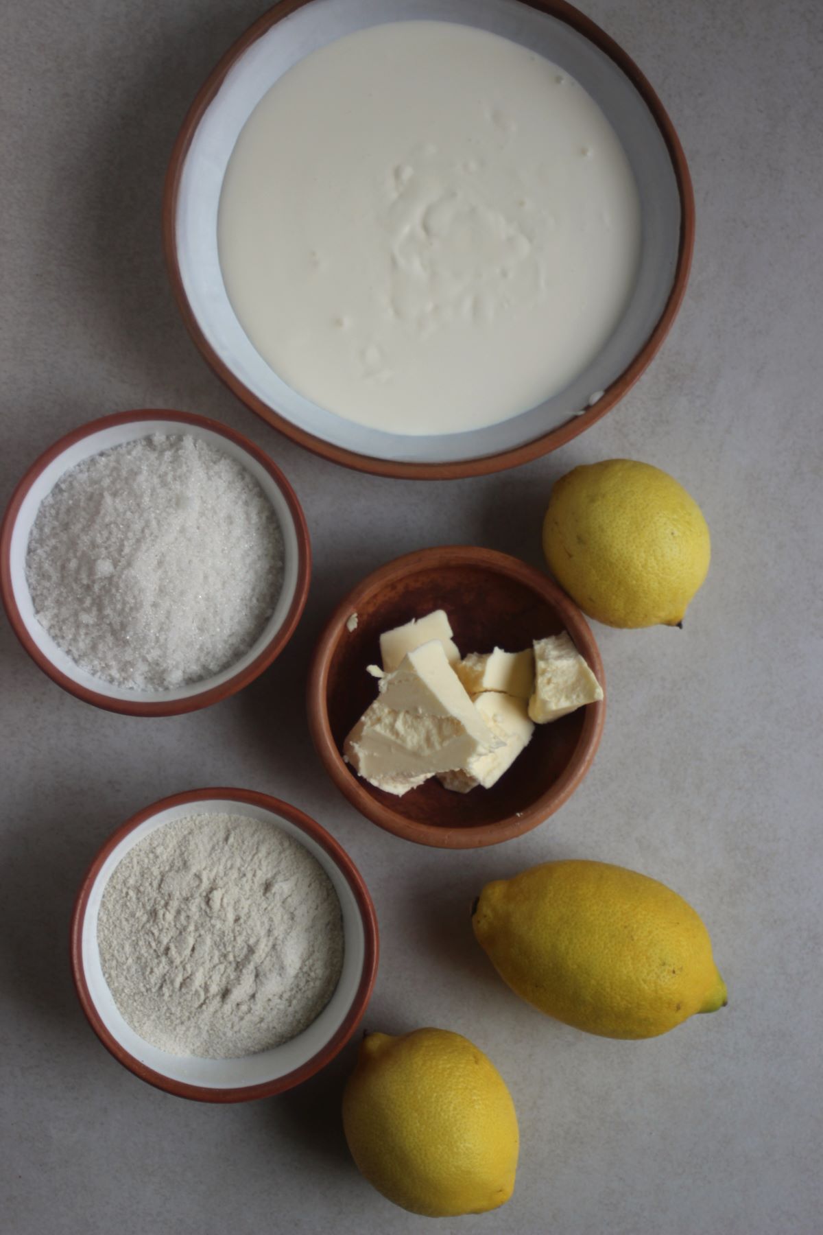 Lemon Posset ingredients on different plates seen from above.