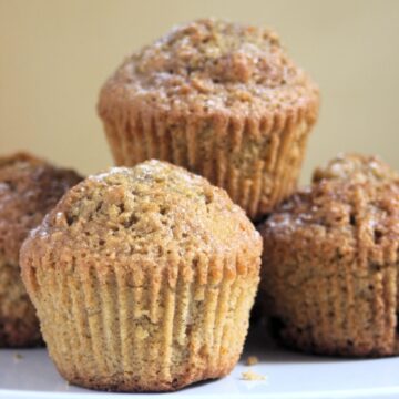 Carrot cake muffins on a white plate. Yellow background.