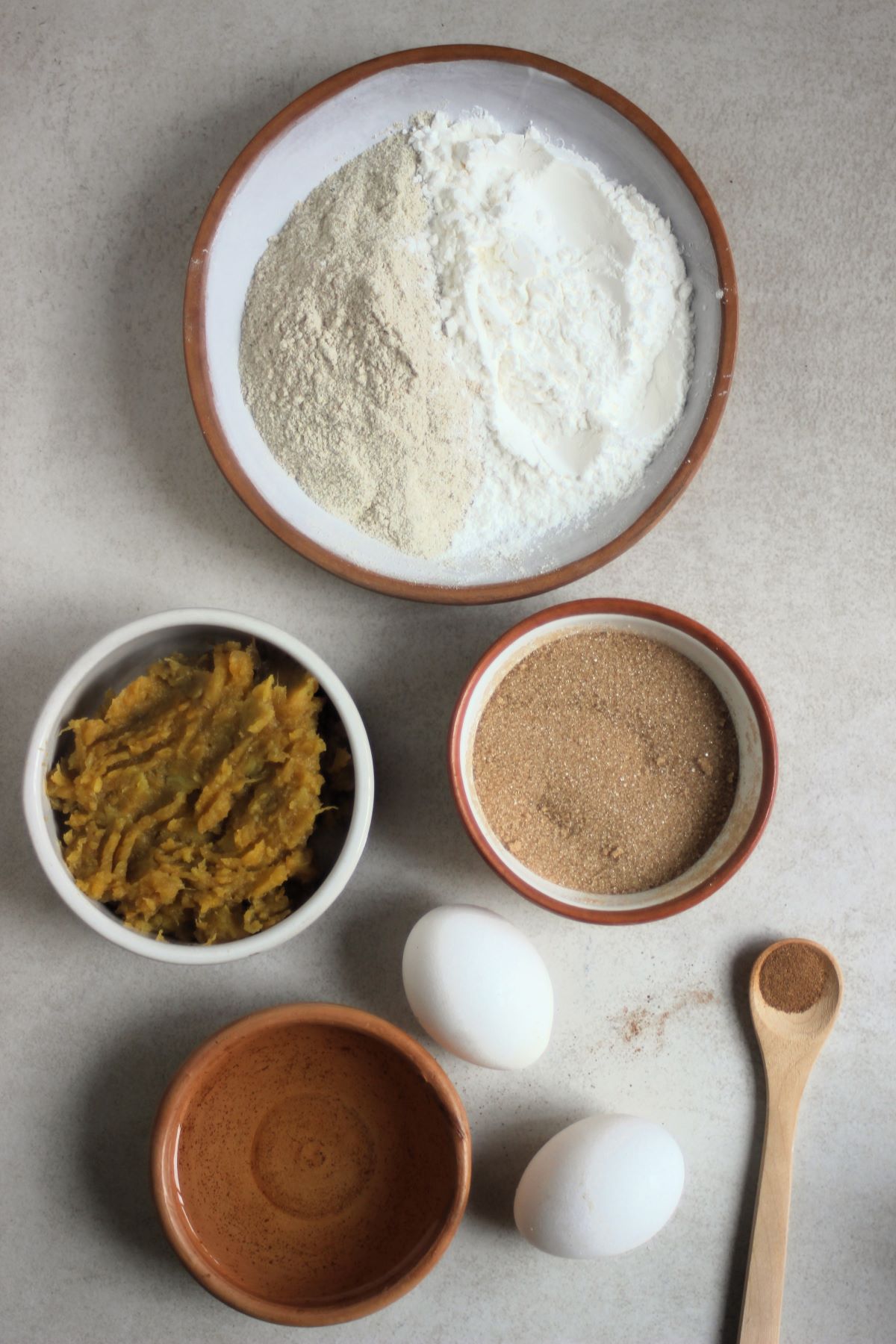 Sweet potato muffins ingredients on a white surface seen from above.