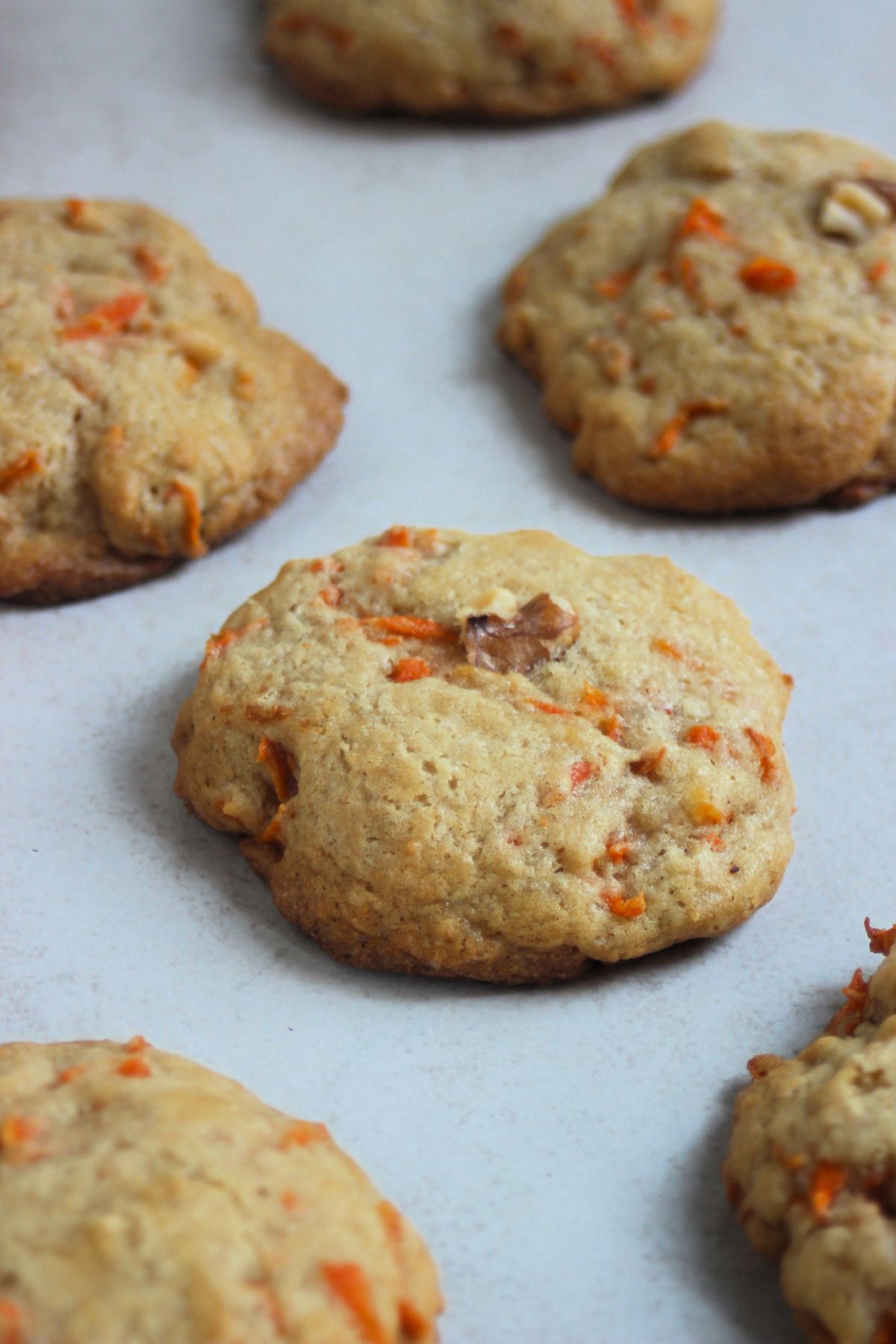 Carrot cake cookies on a white surface.